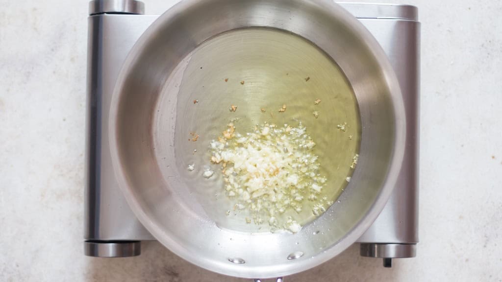 garlic sautéed in olive oil in a skillet.