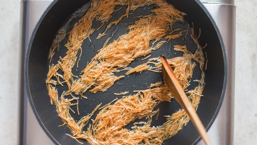 sautéing vermicelli in a skillet.