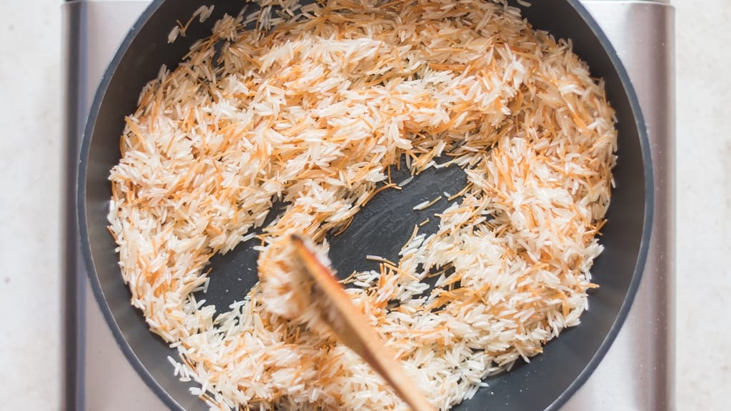 long grain rice and vermicelli sautéed in a skillet.