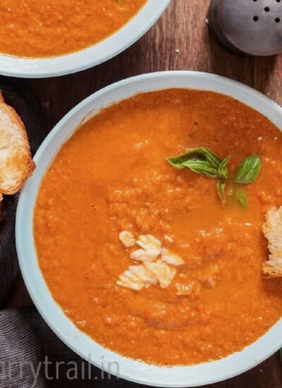 thick tomato soup with basil leaves in a bowl.