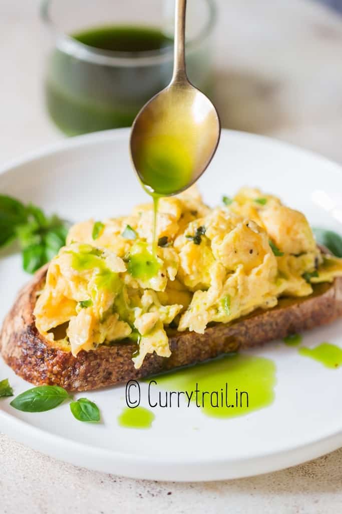 basil oil drizzled over scrambled eggs