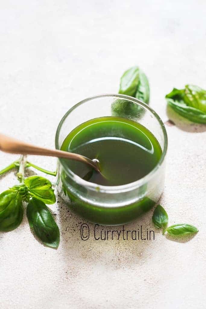 fresh basil infused olive oil in small jar