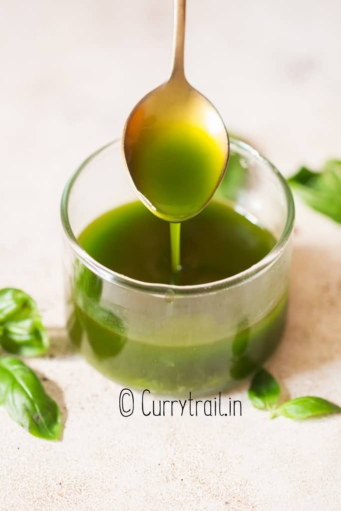 fresh basil infused olive oil in small jar