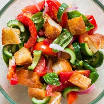 Tuscan tomato and bread salad in served in clear salad bowl.