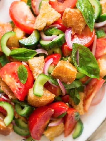 Panzanella Italian bread salad on a white plate.