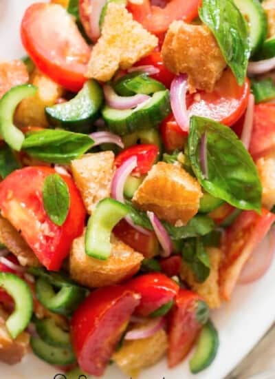 Panzanella Italian bread salad on a white plate.