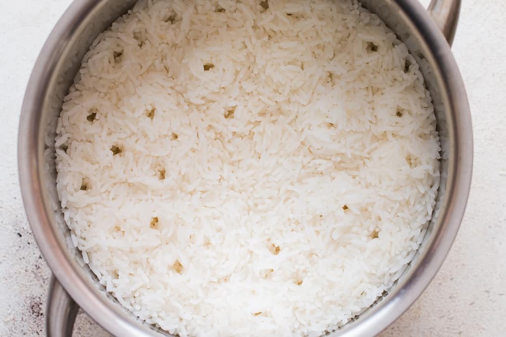 steamed rice in a stainless steel saucepan.