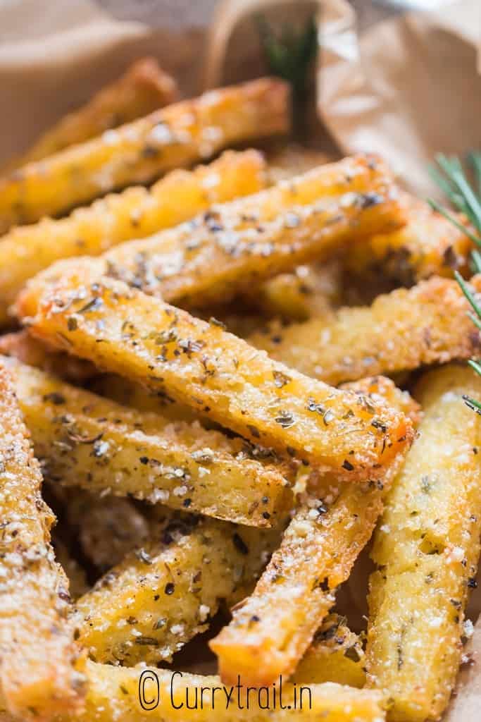 close up view of crispy baked polenta fries with ketchup