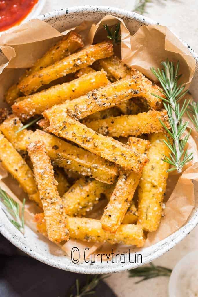 crispy baked fries made of polenta in bowl with ketchup on side