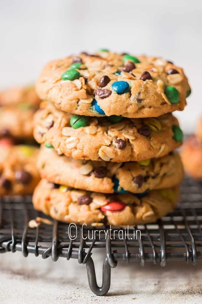 cookie stacked up on one another studded with M&Ms chocolate chips