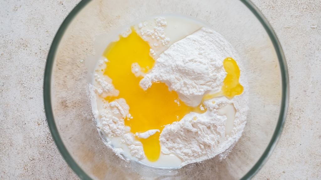 mixing self-rising flour and melted butter in a bowl.