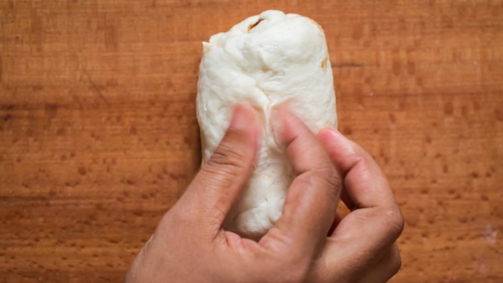 pinching dough ends to stop the filling from oozing out.