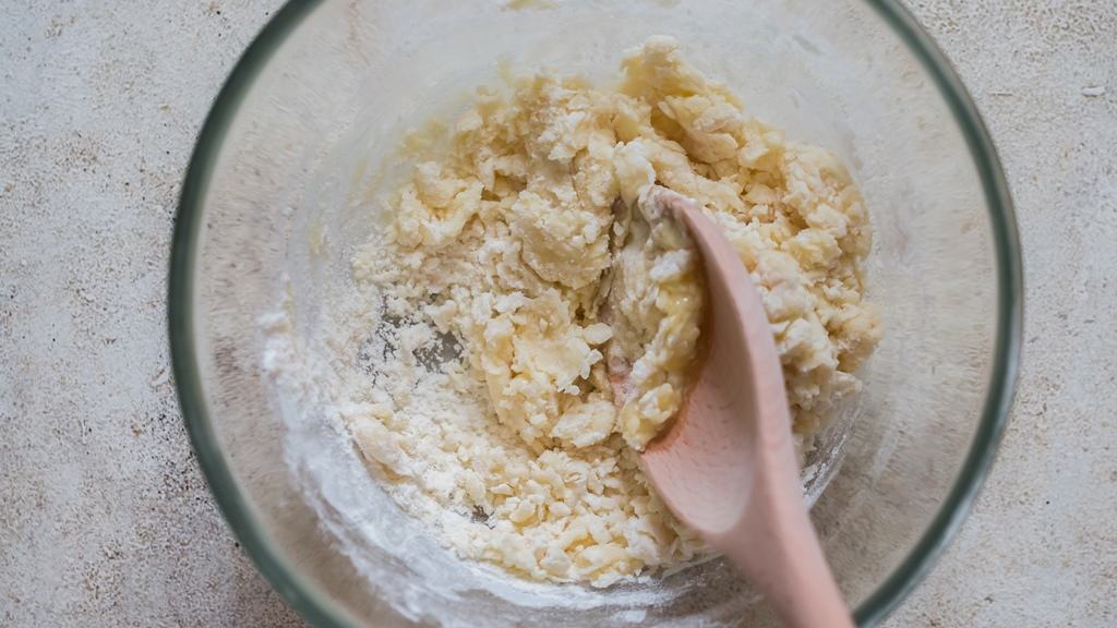 mixing self-rising flour and melted butter in a bowl.
