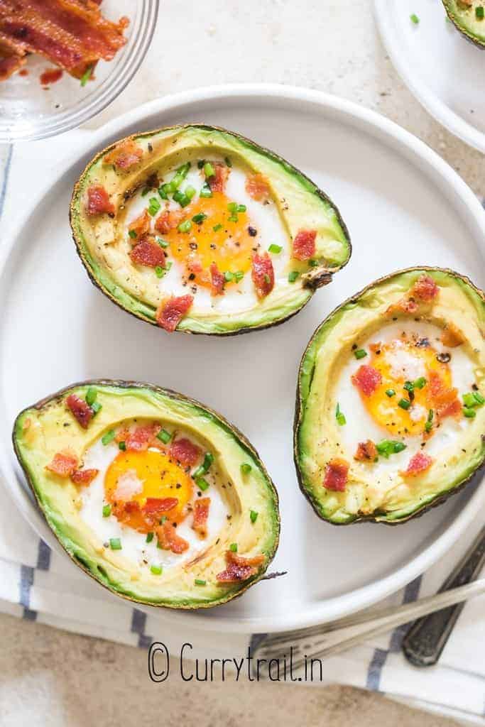 egg in avocado with bacon and chives