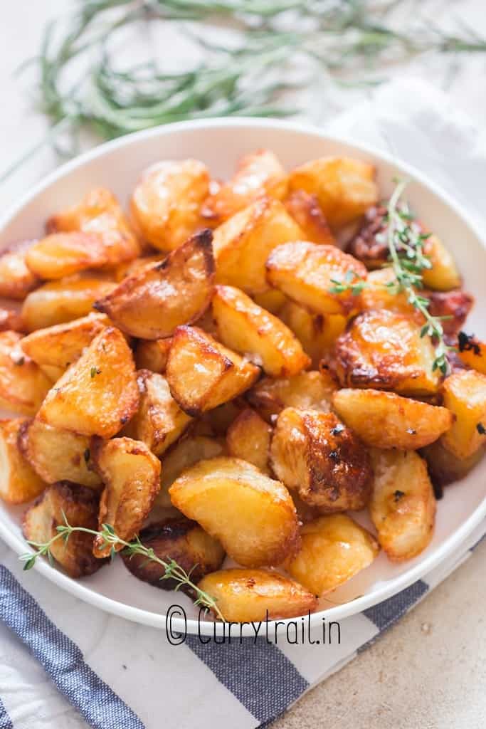 crunchy roast potatoes with thyme rosemary and sea salt in a plate