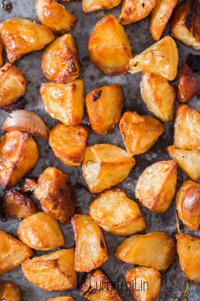 close up view of roast potatoes in baking dish