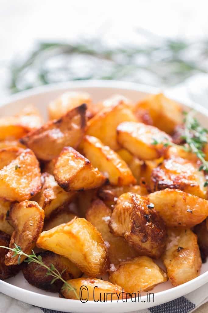 best roast potatoes on plate with thyme