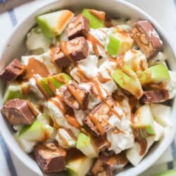 snickers and apple salad in white bowl