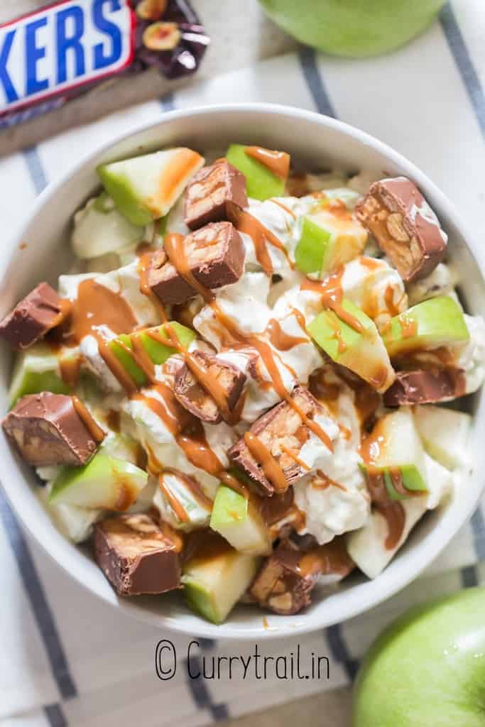 snickers and apple salad in white bowl