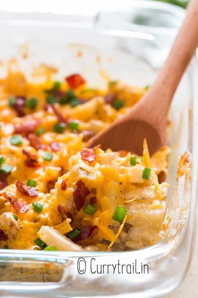 close view of creamy cheesy loaded potatoes baked in casserole dish
