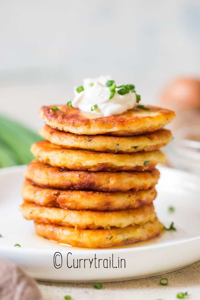 stacks of mashed potato pancakes with sour cream and chives