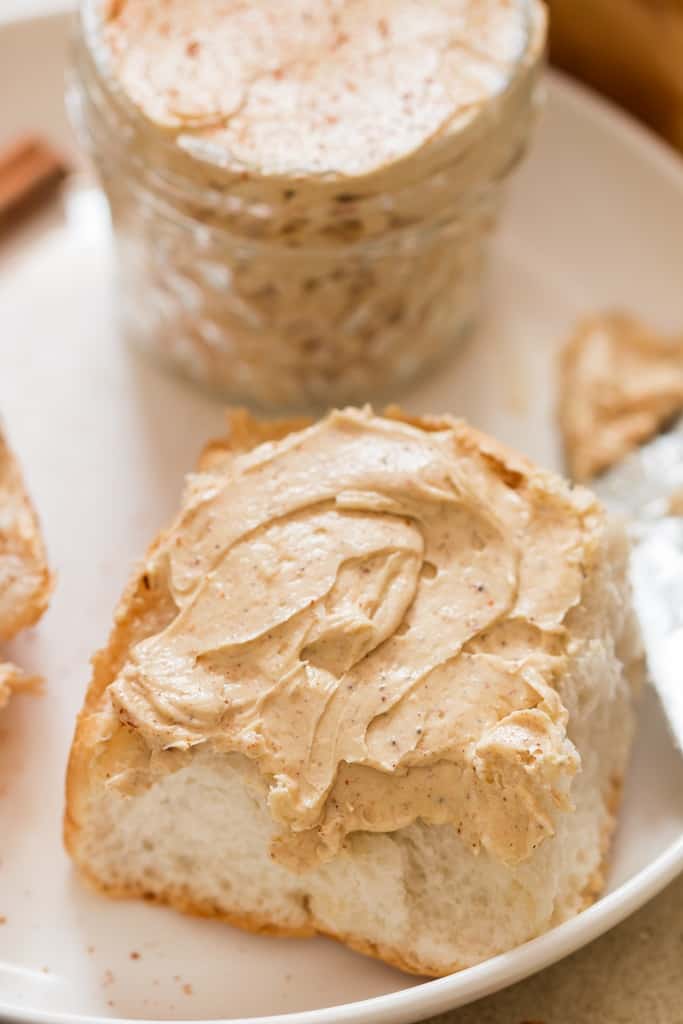 dinner roll slathered with cinnamon honey butter