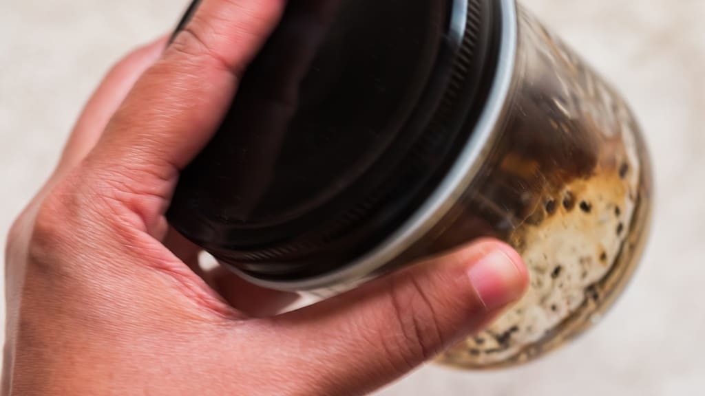 shaking salad dressing in a jar.