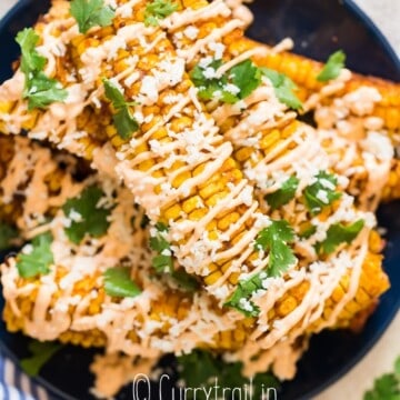 stacks of corn ribs on plate with chili mayo and Cotija cheese