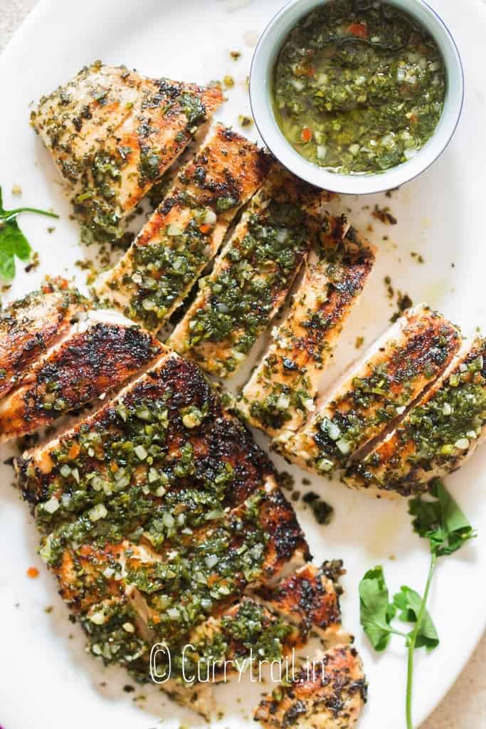sliced grilled chicken with chimichurri sauce topping