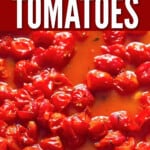 close up view of roasted juicy cherry tomatoes in baking tray with text.