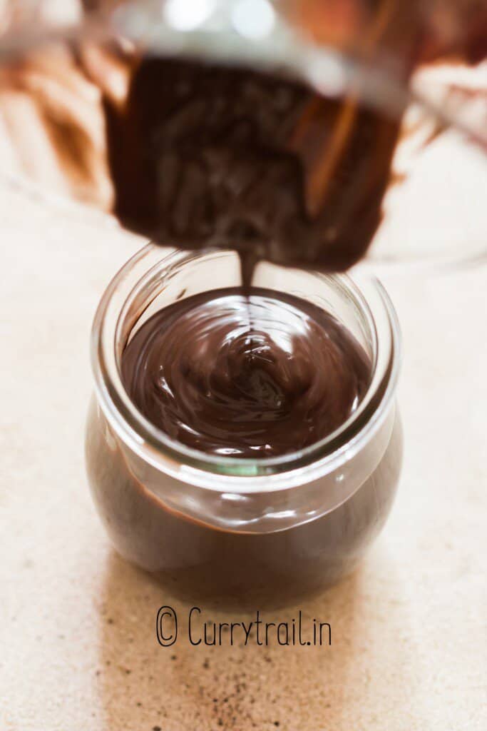 pouring chocolate syrup into mason jar