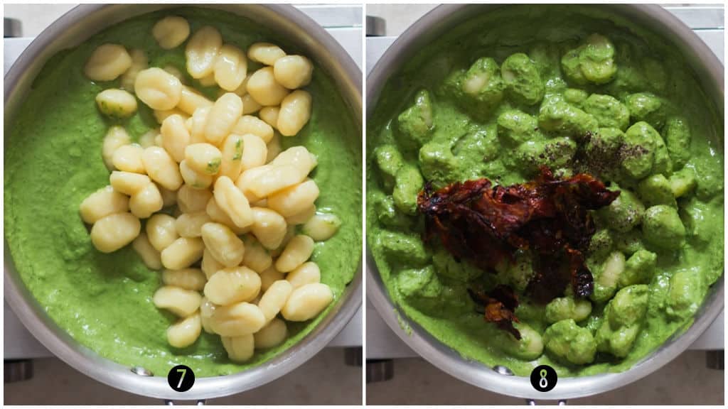 gnocchi stirred in pesto cream sauce in a skillet.