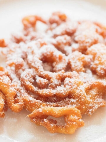 crispy funnel cake with powdered sugar