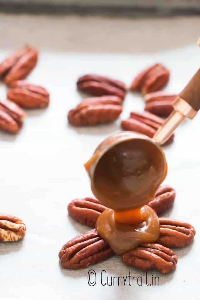 pouring caramel sauce over pecan clusters