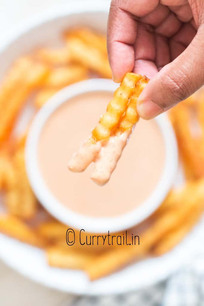 French fries dipped in sauce