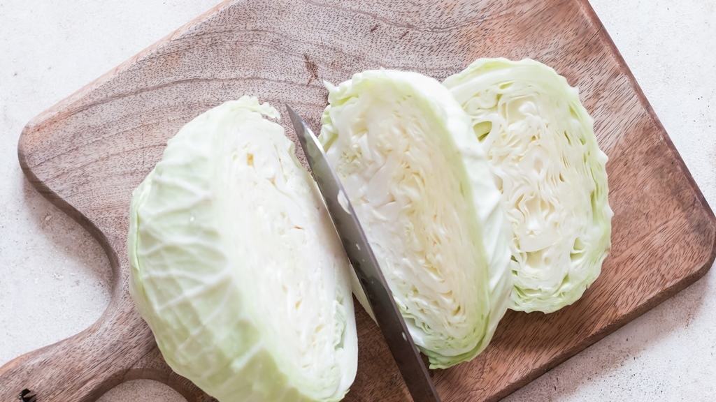 cutting cabbage head into thick steaks.