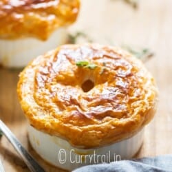 puff pastry topped small pot pie with chicken filling