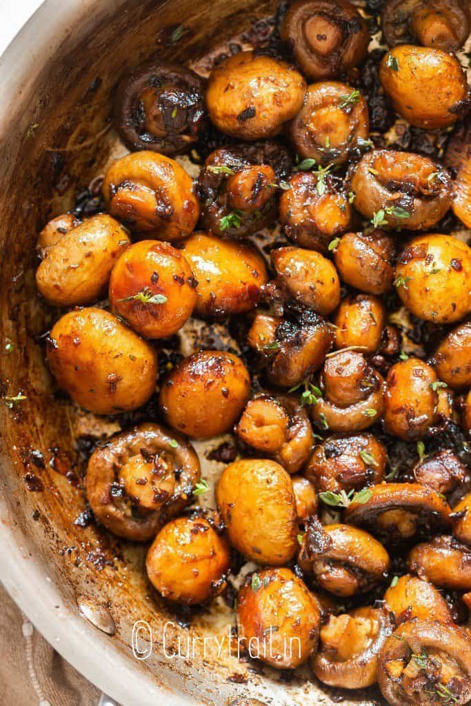 close view of mushroom cooked in garlic butter sauce