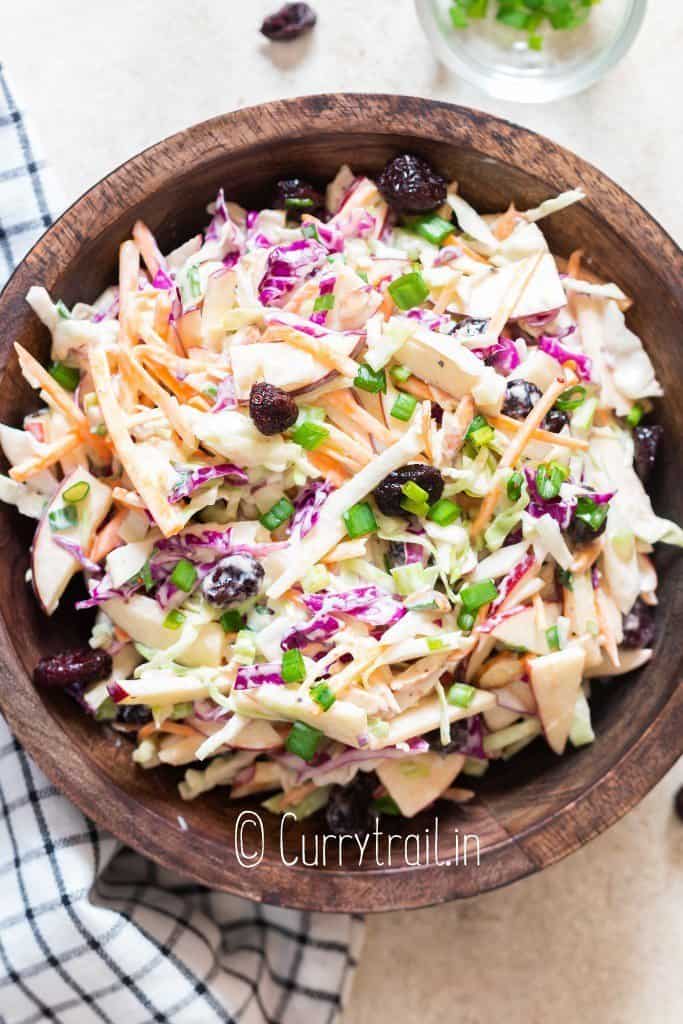 apple slaw with cranberries and almonds in bowl