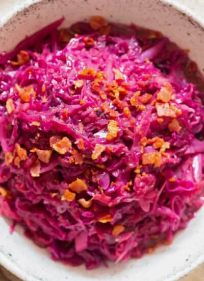 red cabbage braised with apples served in white bowl