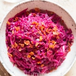 red cabbage braised with apples served in white bowl