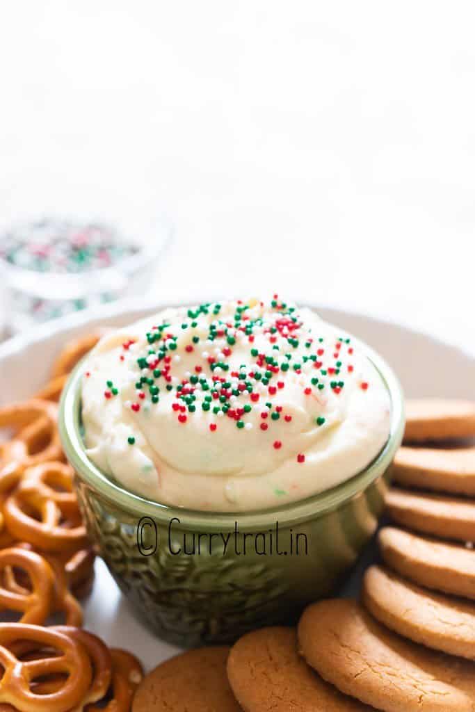 close view of Christmas dip with cookies and pretzels