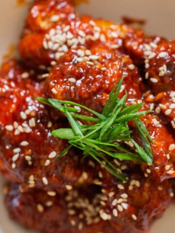 close view of sticky sweet spicy fried chicken with Korean sauce