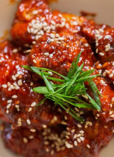 close view of sticky sweet spicy fried chicken with Korean sauce