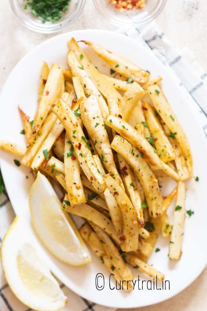 baked parsnips with parsley and lemon on plate