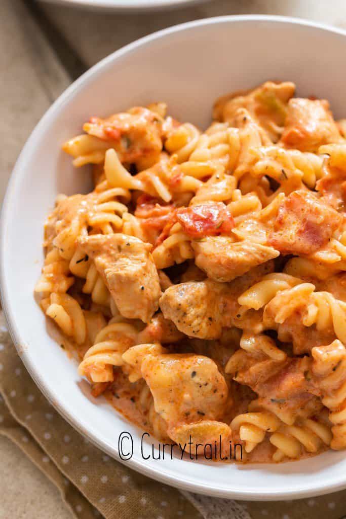 close view of tomato pasta with chicken