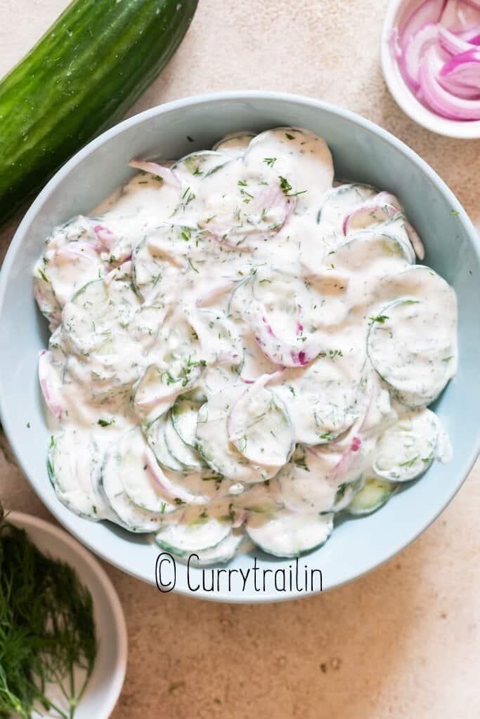 cucumber salad in creamy sour cream dressing in bowl