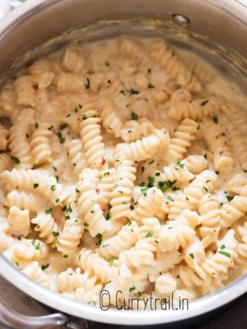 garlic pasta in cream sauce in a pot.