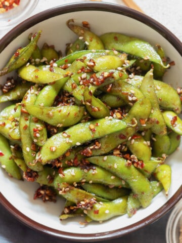 bowl of spicy garlic edamame with toasted sesame seeds