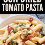 creamy sun dried tomato pasta in bowl with text overlay